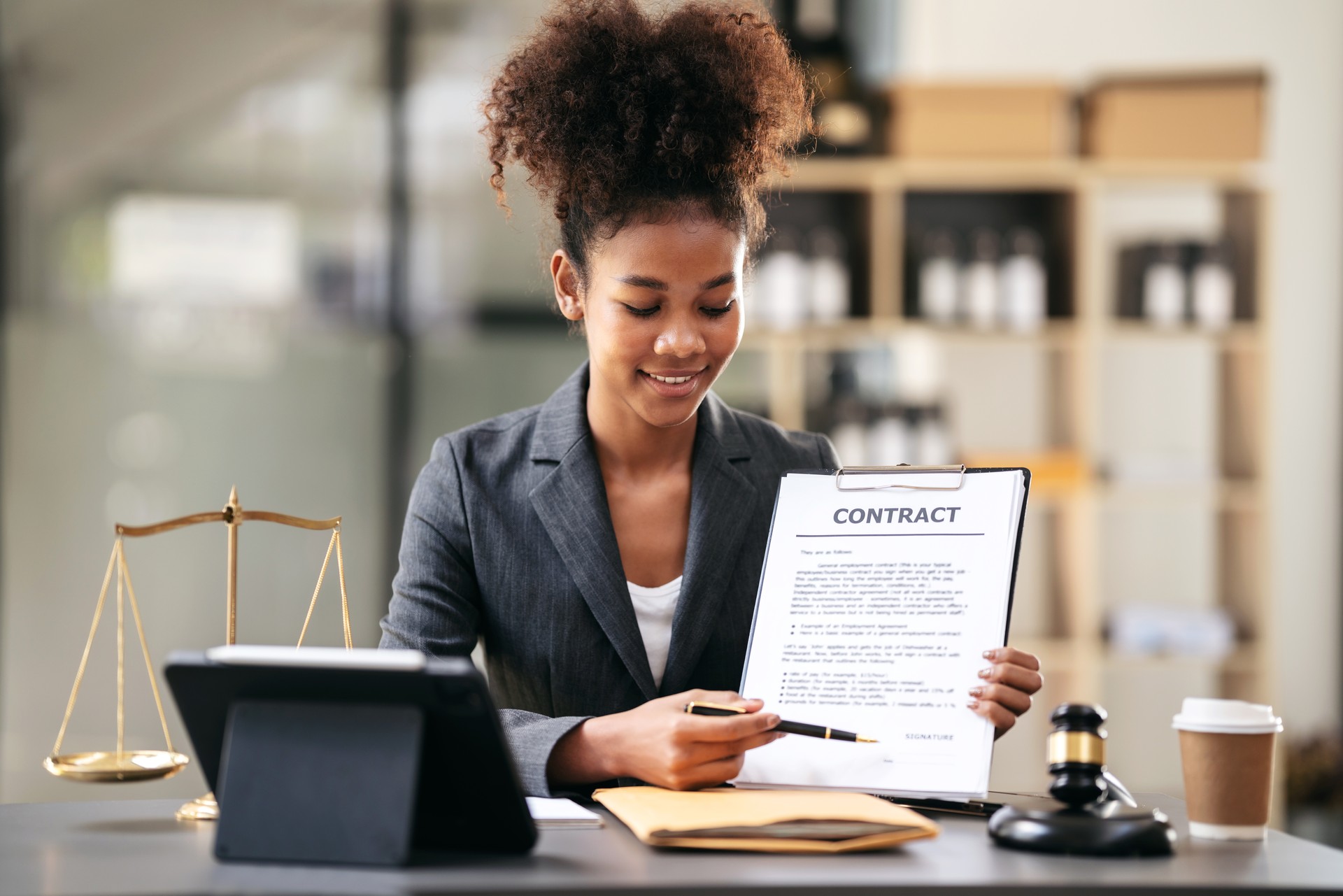 African american lawyer woman in suit pointing on business contr